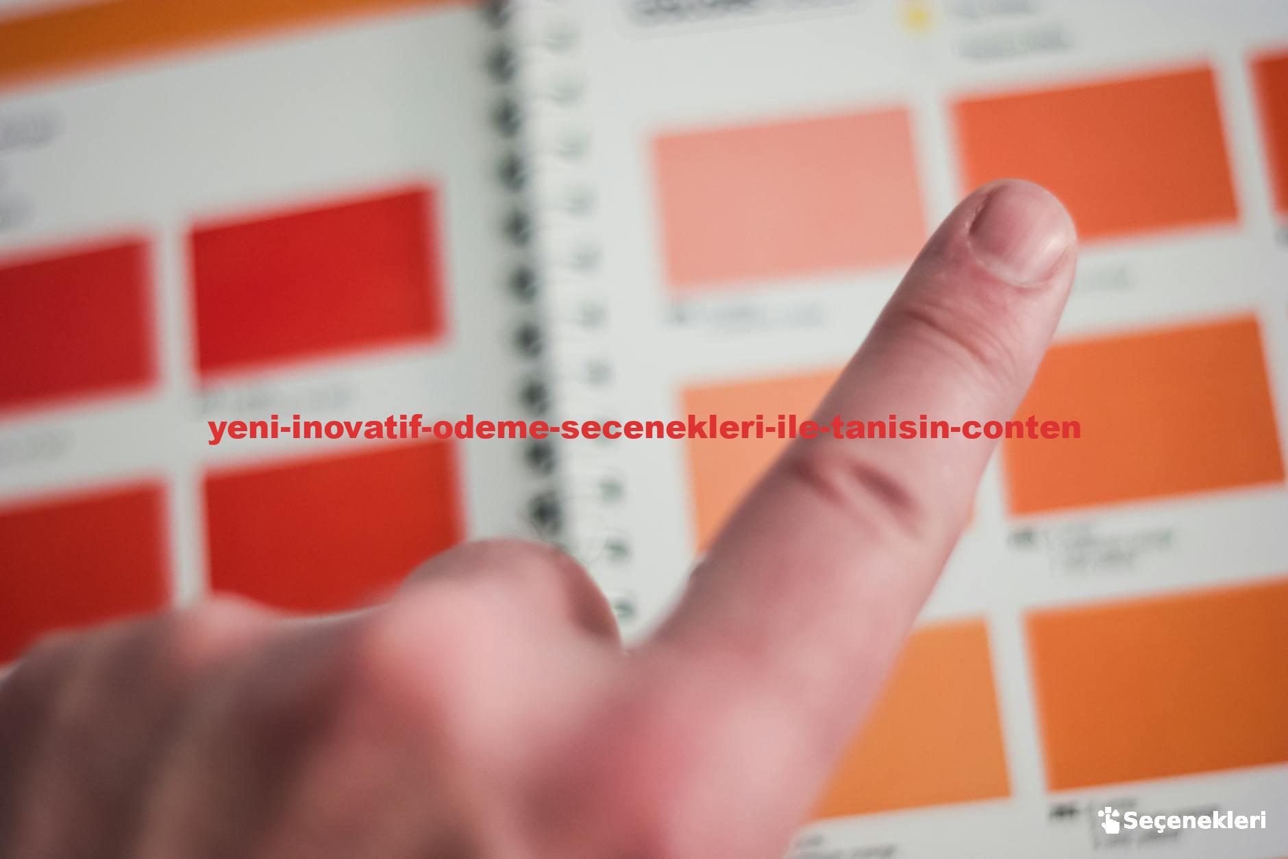 A finger points at a color swatch on a vibrant palette inside an office environment.