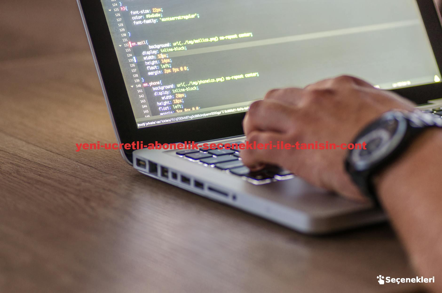 A close-up shot of a person coding on a laptop, focusing on the hands and screen.