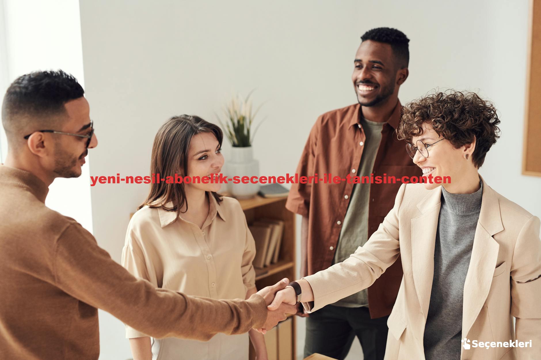 Four colleagues smiling and shaking hands in a bright office setting.
