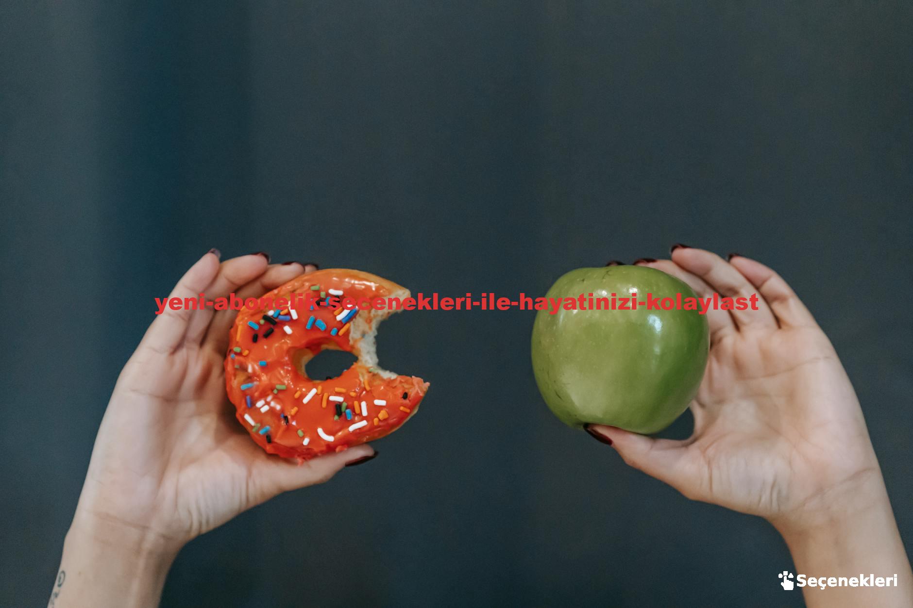 Crop unrecognizable young female demonstrating bitten high calorie doughnut and healthy green apple against gray background